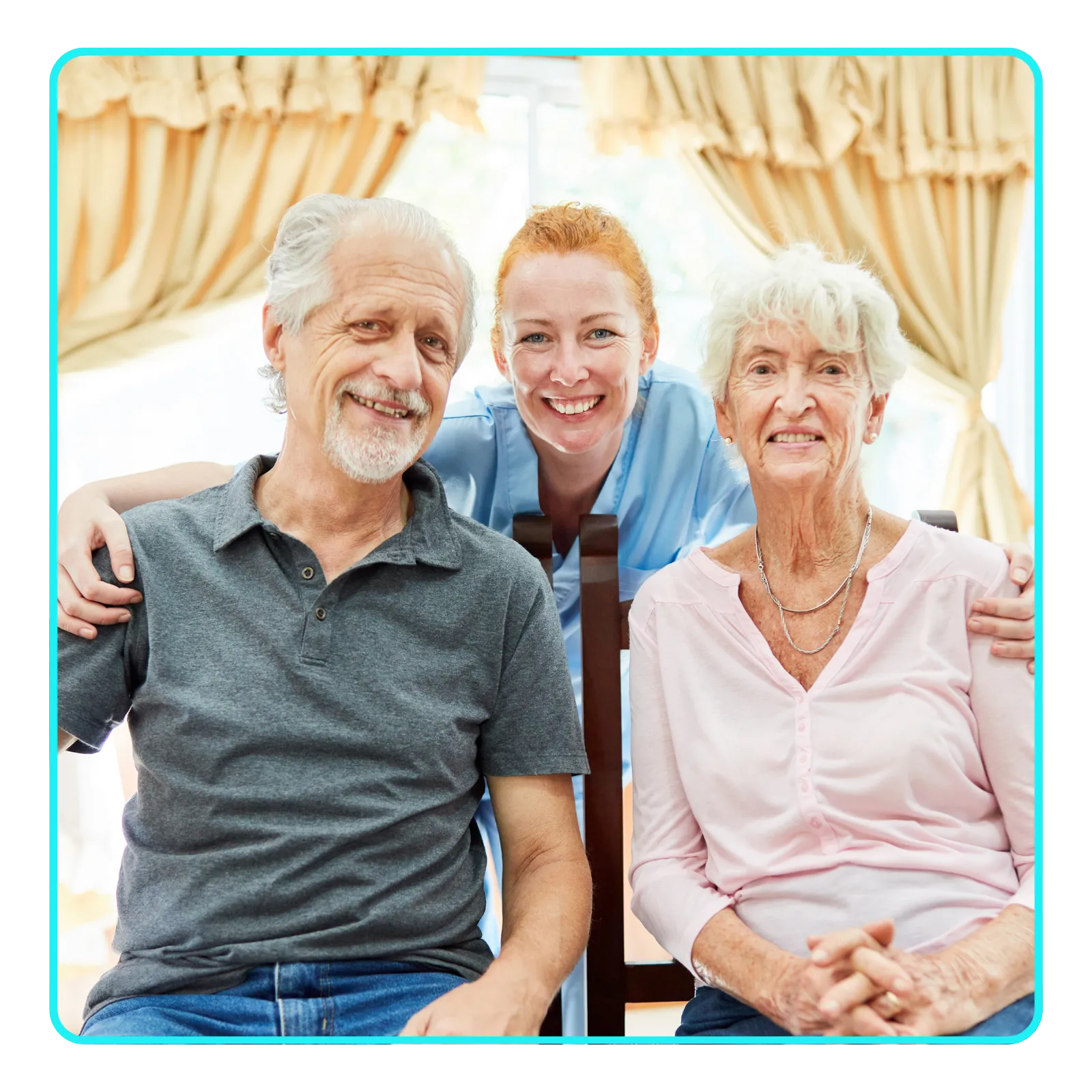 Smiling caregiver with elderly couple at home