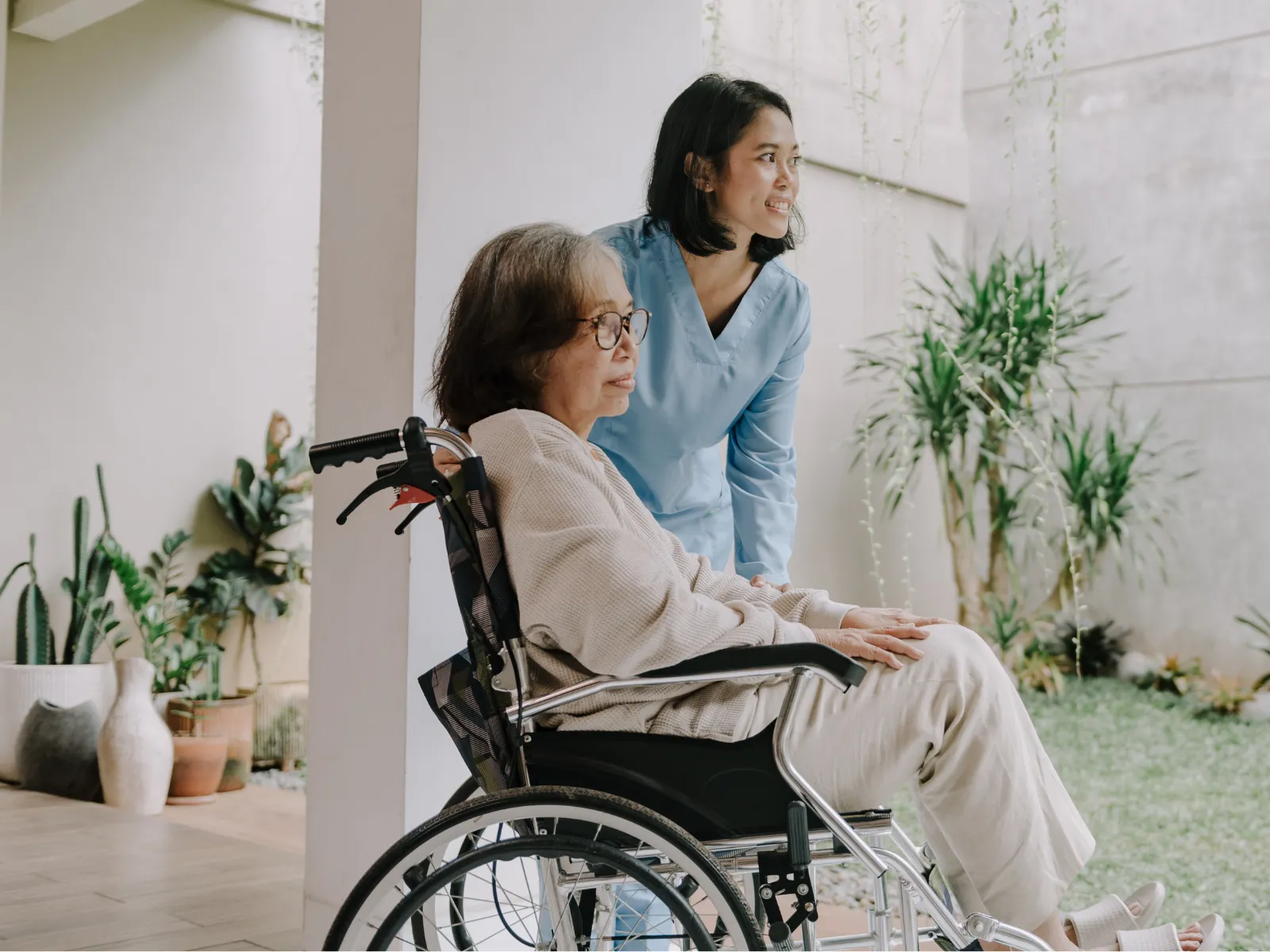 Caregiver with elderly woman in wheelchair