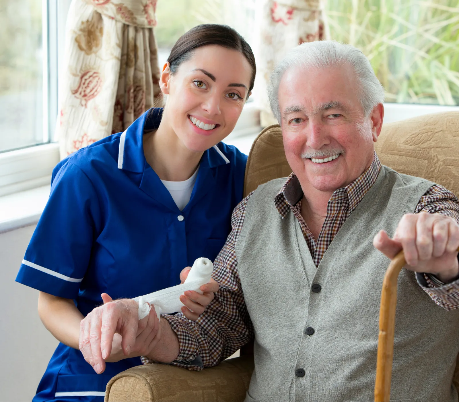 Nurse helping elderly man with walking cane