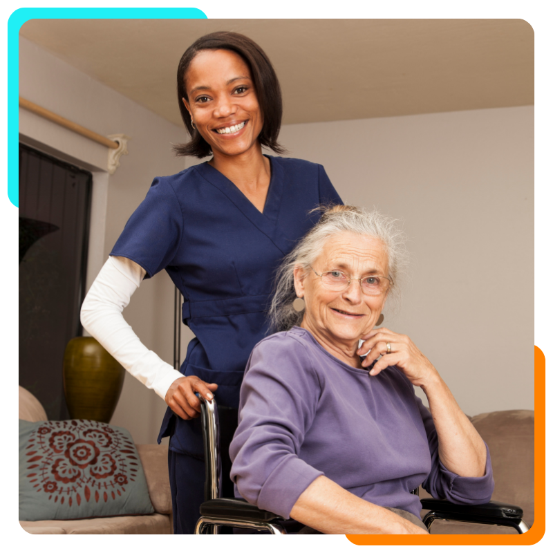 Smiling caregiver with elderly woman in wheelchair