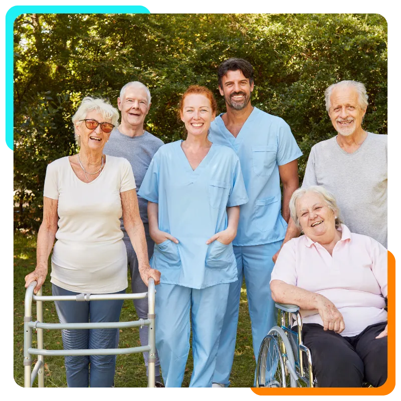 Caregivers and senior residents smiling outdoors