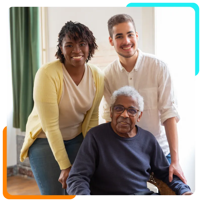 Smiling elderly man with two family members