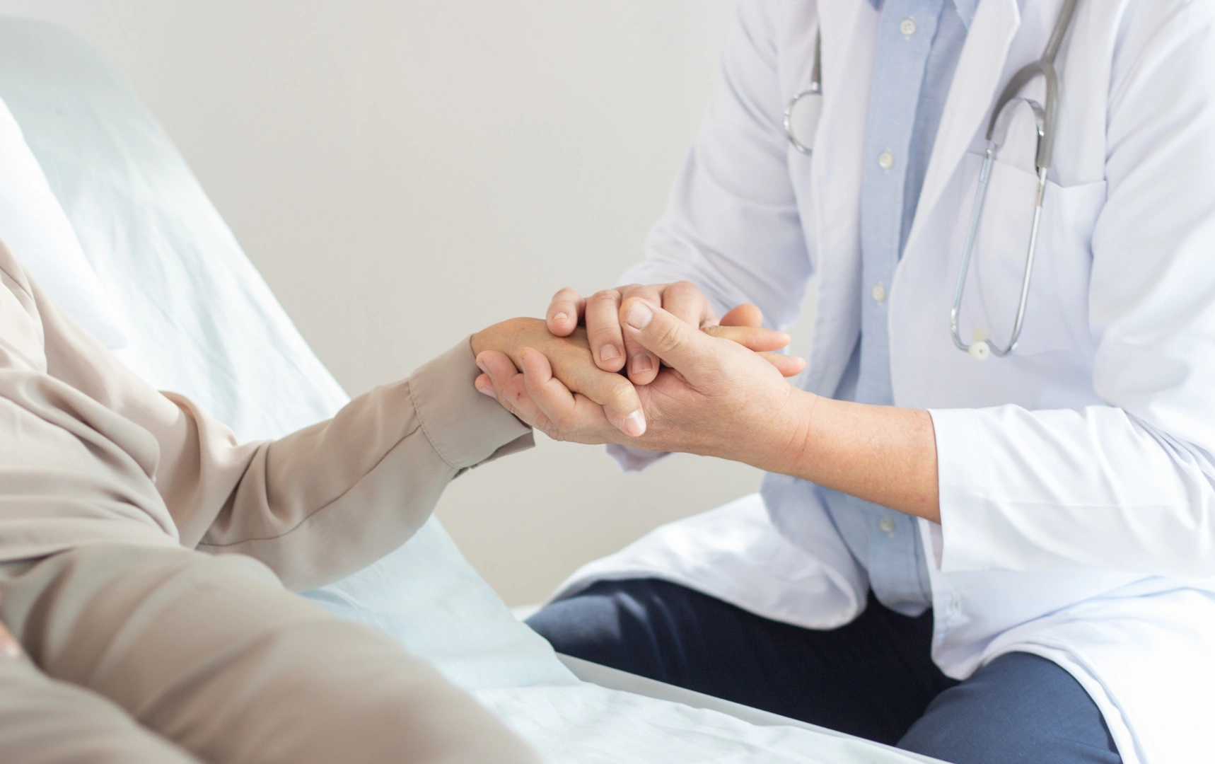 Doctor holding patient's hand