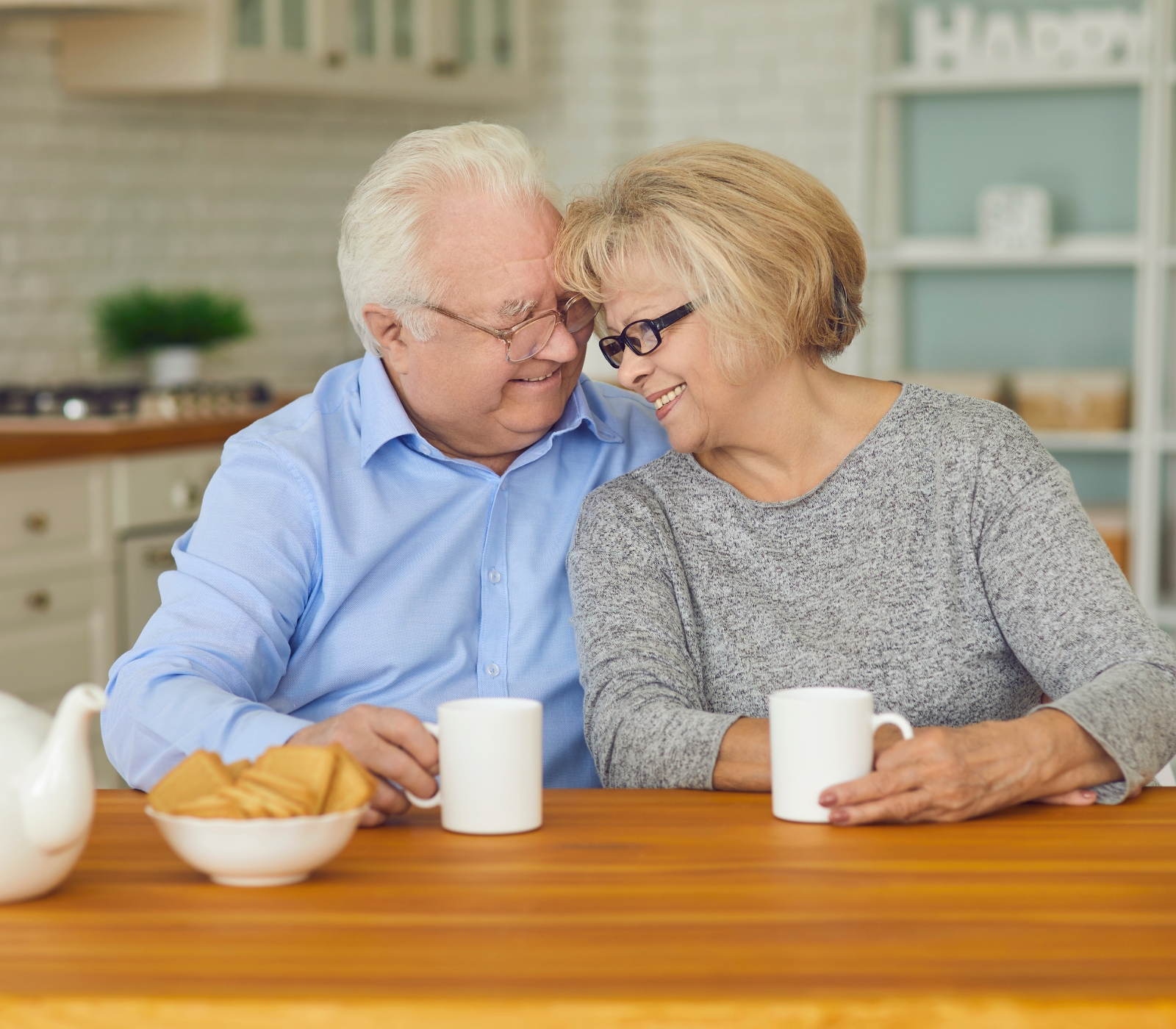 Smiling senior couple sharing coffee at table