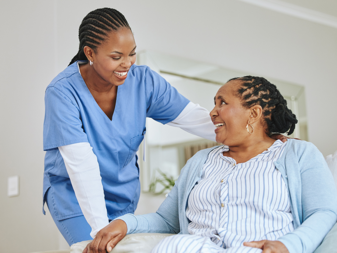 Caregiver holding hands with smiling patient