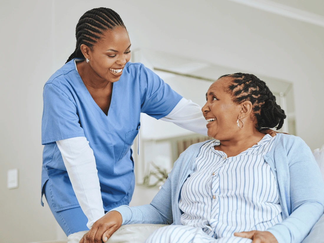 Nurse holding hand of smiling patient